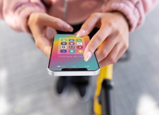 close up hands holding phone with apps